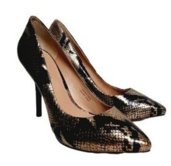 Via Spiga shoe collection display featuring elegant stiletto heels and suede wedge pumps